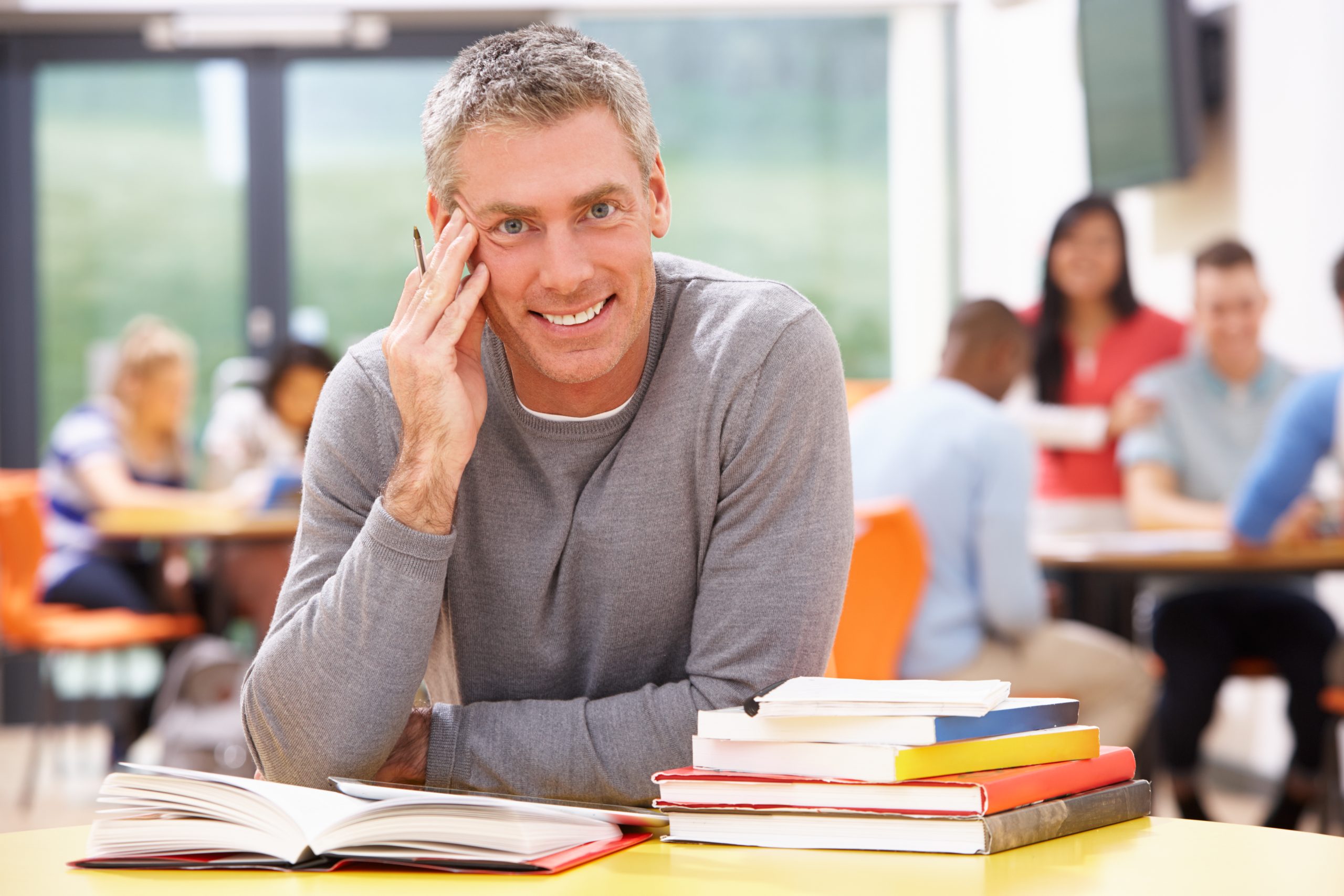 SP Training Male Mature Student Studying In Classroom With Books